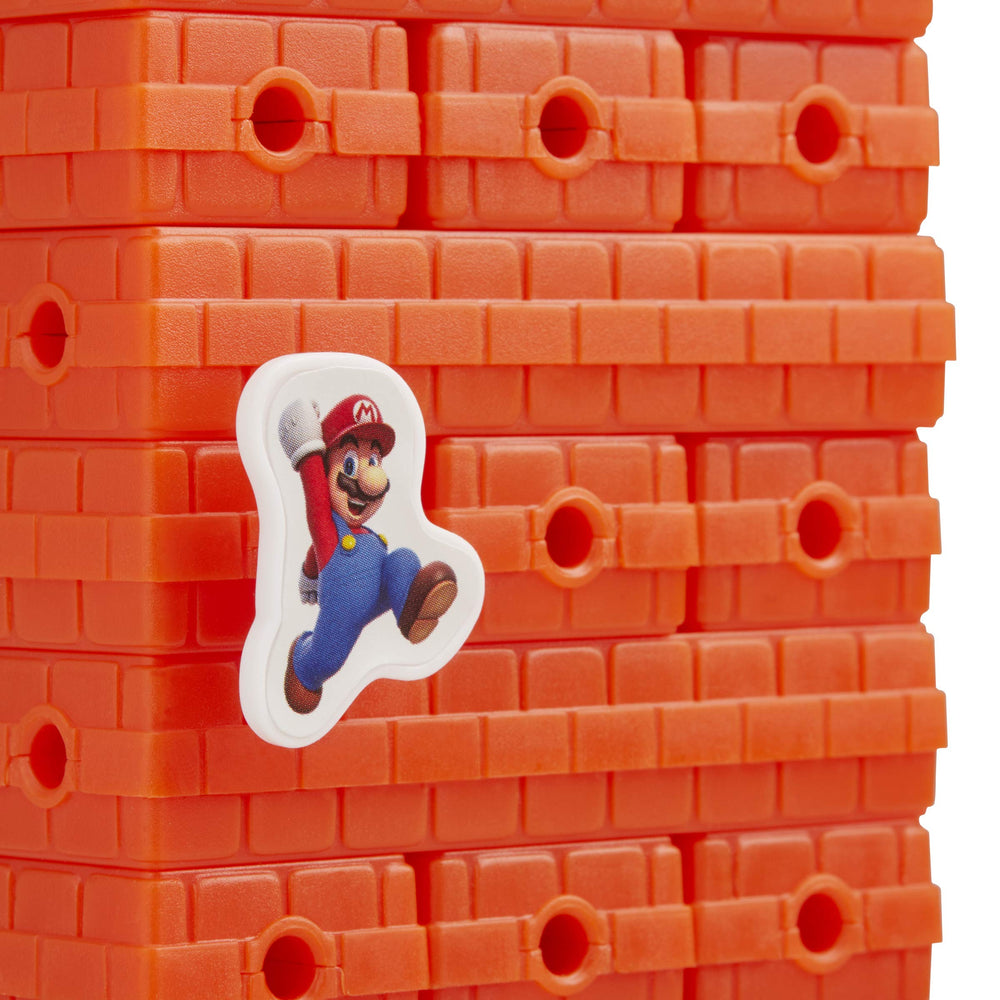 Hasbro Jenga: Super Mario Edition pegs—precise placement challenges players.