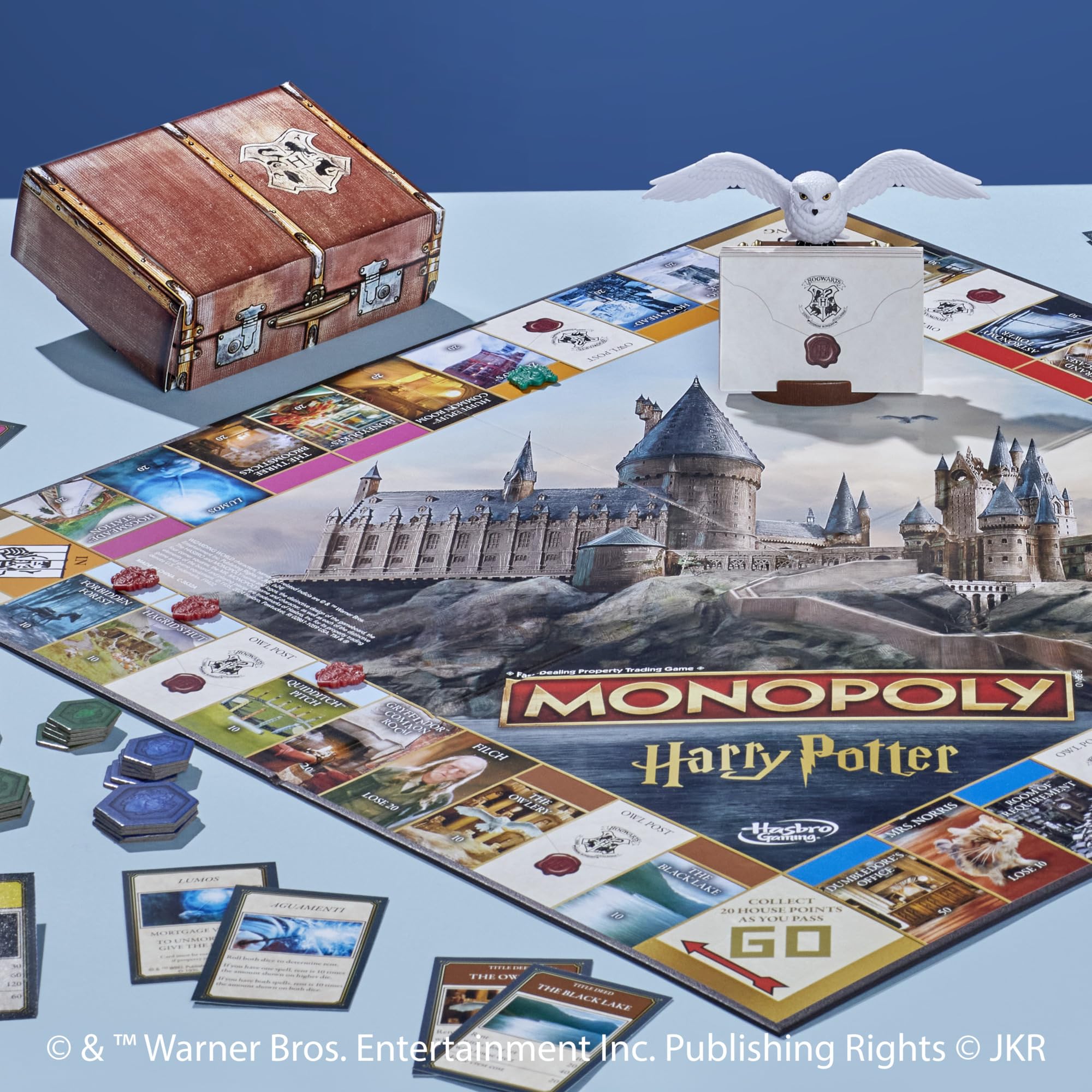 Six golden tokens evoke magical transport in Hasbro Monopoly Harry Potter Edition.
