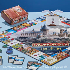 Six golden tokens evoke magical transport in Hasbro Monopoly Harry Potter Edition.