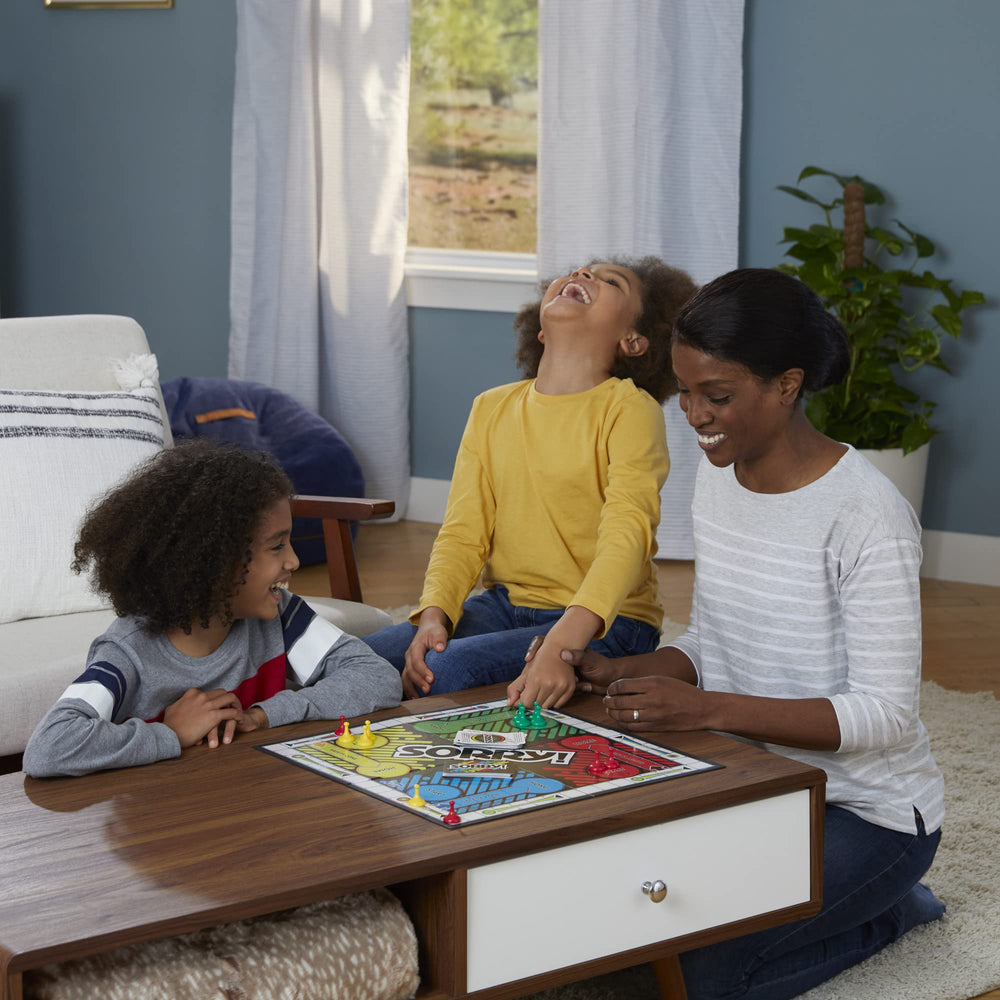 Hasbro Gaming Sorry! pawns beside a hand showing size and easy handling for children