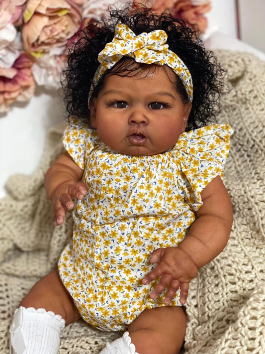 Hengluck lifelike reborn baby doll 24in front view highlighting realistic features and portable size.