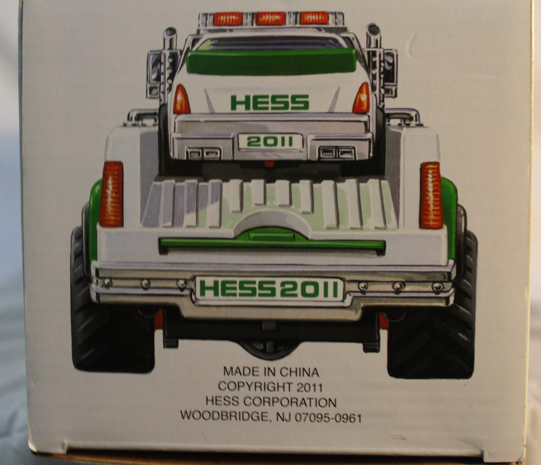 Hess race car lights illuminated for authentic nighttime display.