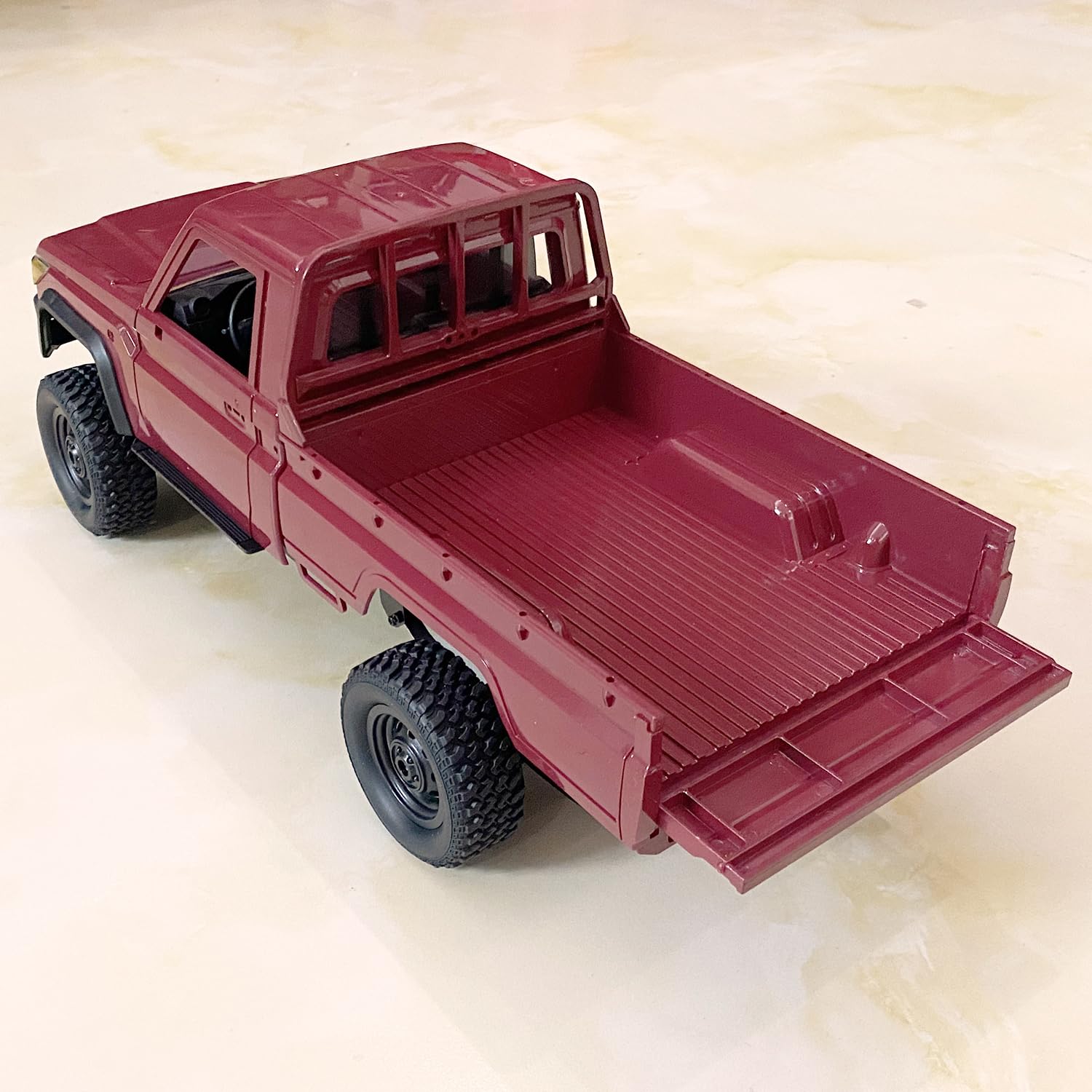 HLSFWDRIVE MN82 RC Rock Crawler side view highlights scale and durable chassis for rugged terrain