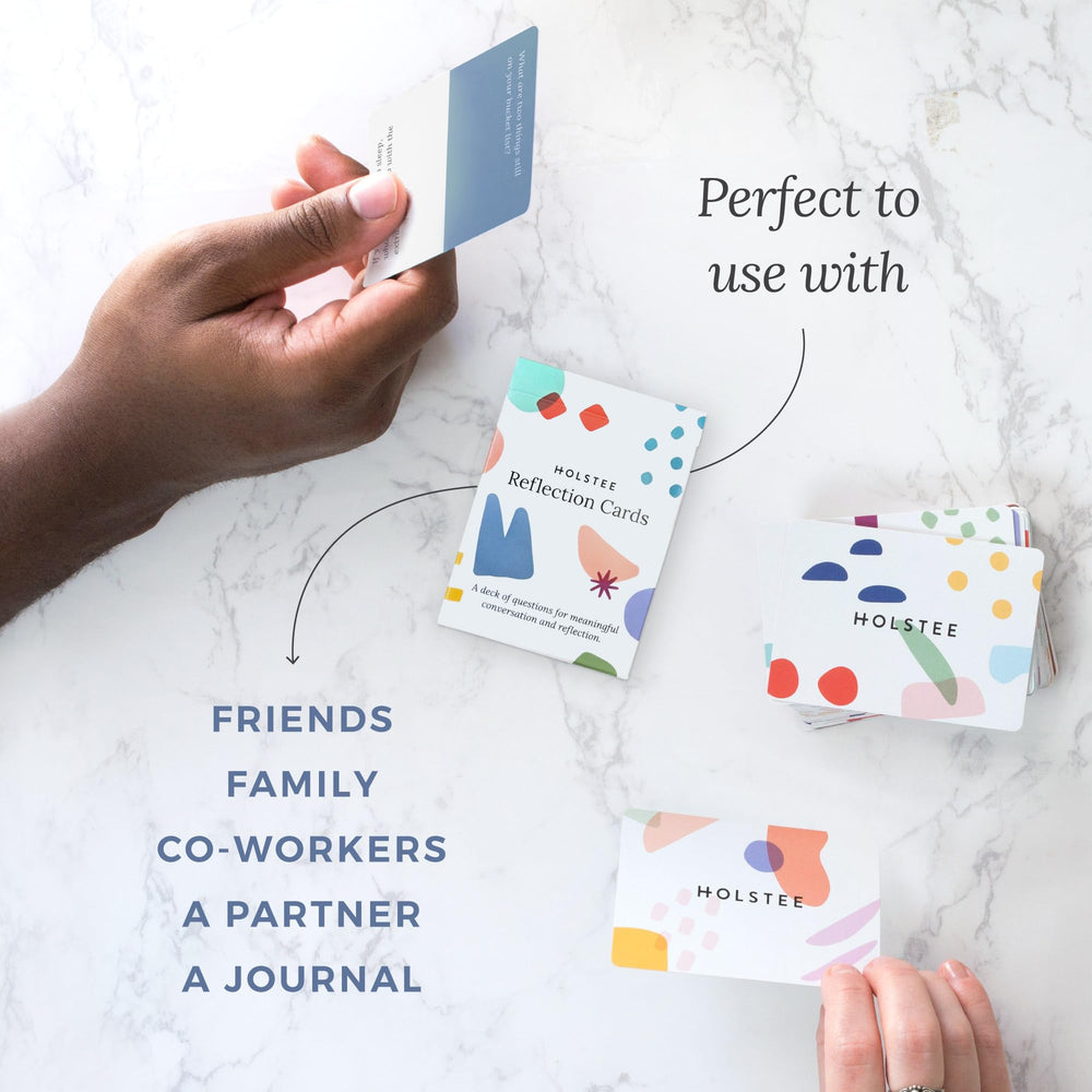 Holstee Reflection Cards pack resting beside a cozy coffee moment.