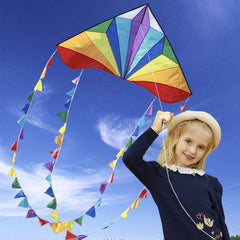 Honbo delta kite with rainbow tails catching the wind for kid-friendly play.
