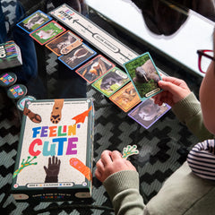Players around a table enjoy Feelin' Cute quick rounds.