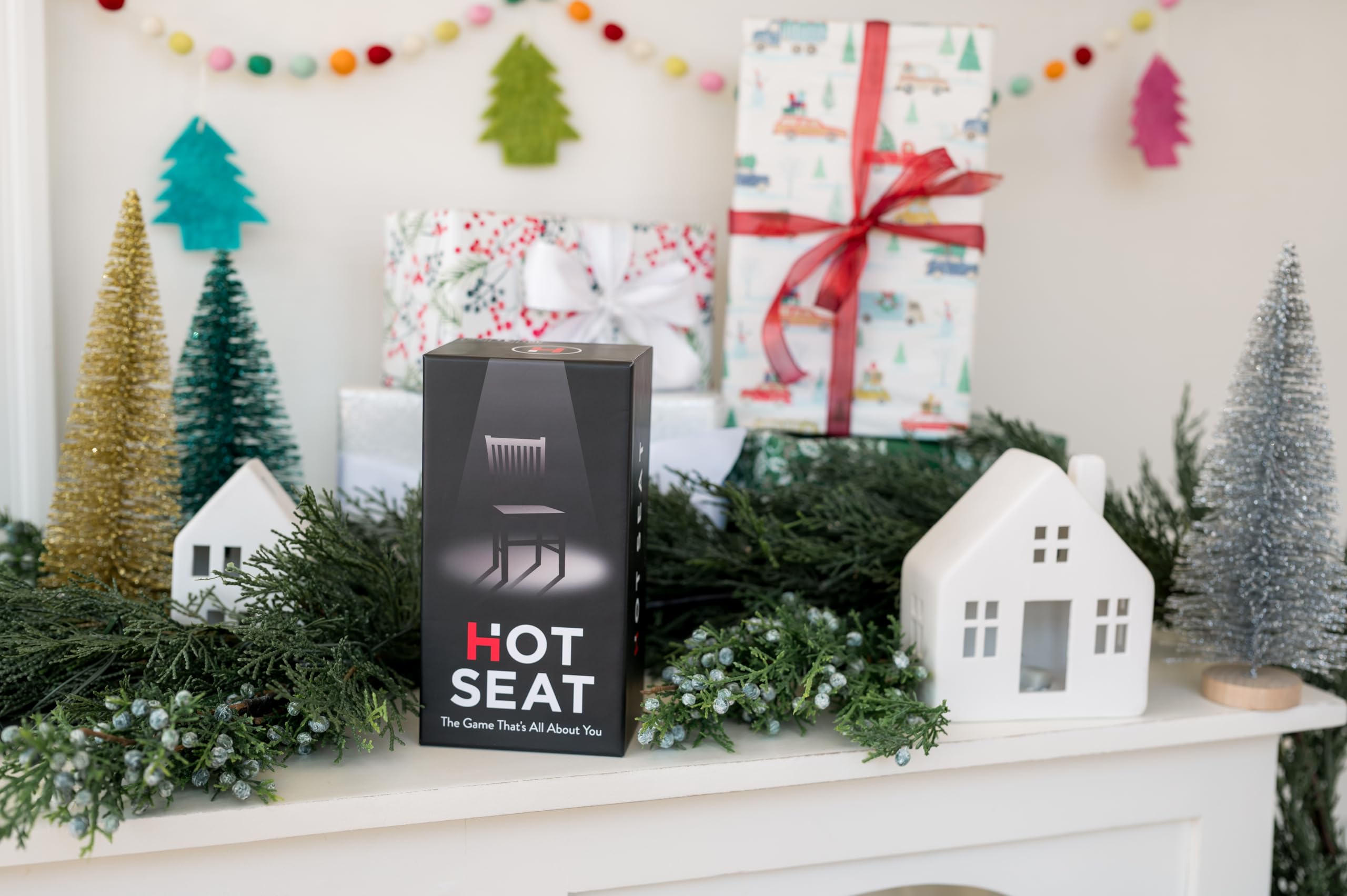 Hot Seat card draw shows anonymous answers fueling playful guessing.