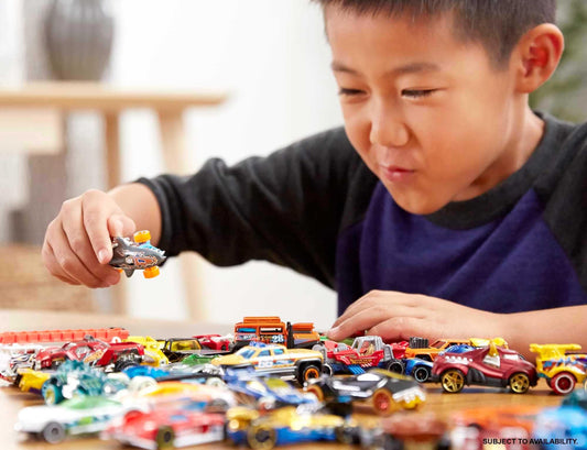 Hot Wheels 20-pack variety of vehicles shown on track for play