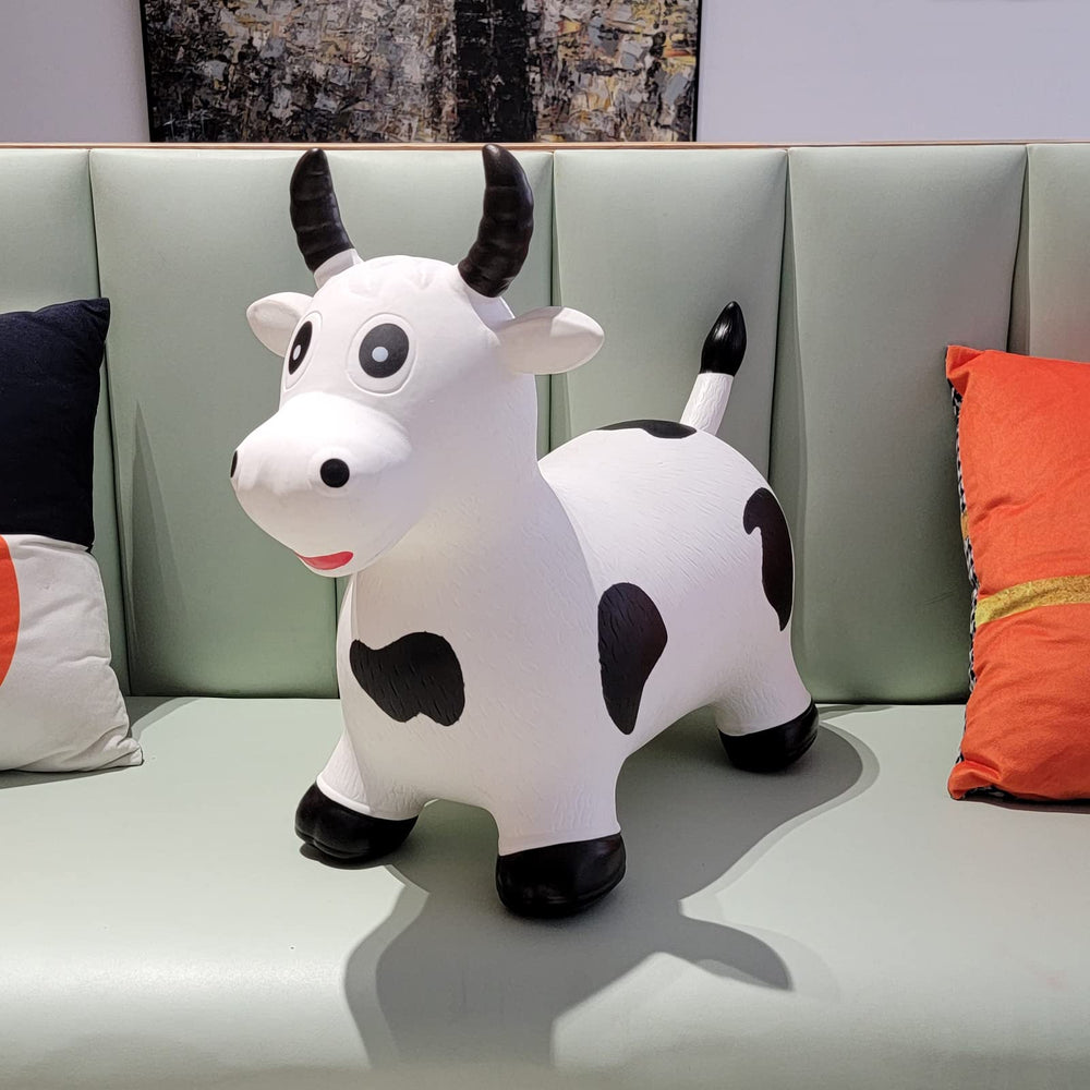 Children enjoy indoor outdoor play on HotMax bouncy cow hopper.