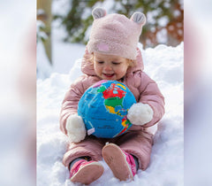 Hugg-A-Planet Baby Earth by the bed, ideal bedtime companion.