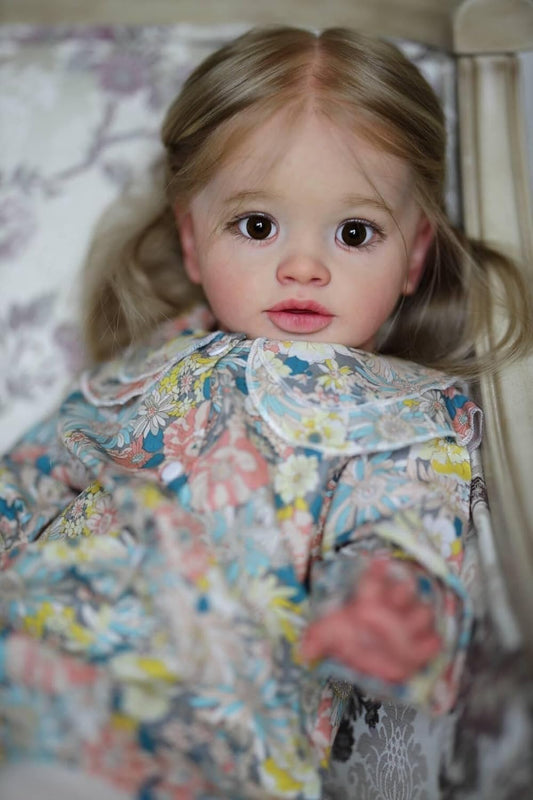 iCradle 26-inch reborn toddler doll with poseable limbs for lifelike play sessions.