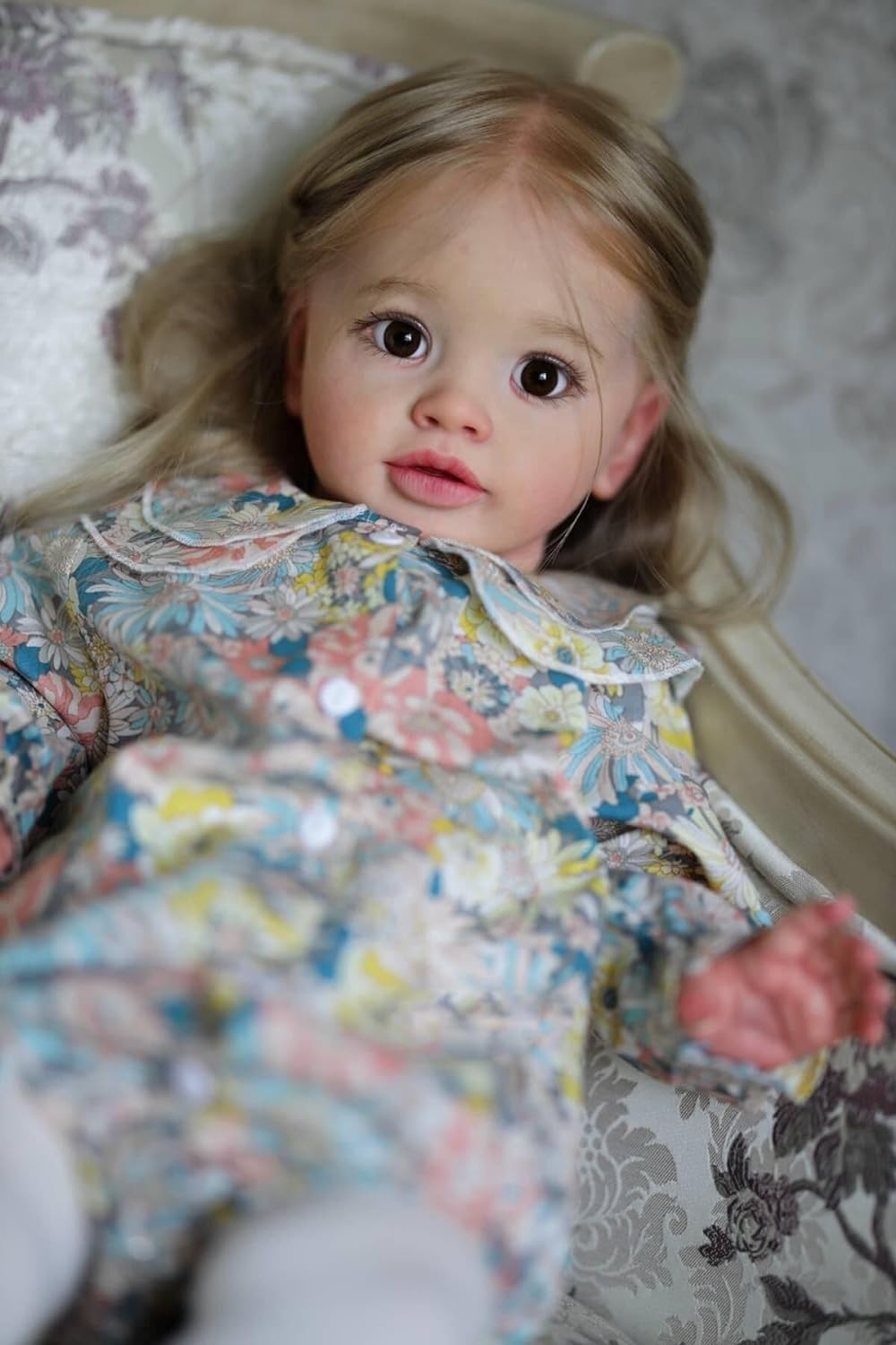 iCradle realistic doll with cloth body and soft vinyl limbs for gentle handling.