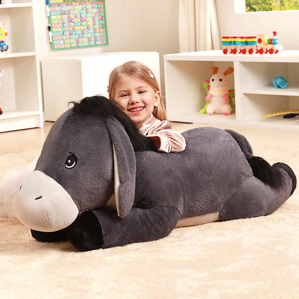 IKASA giant donkey plush placed in a bedroom setting for decor