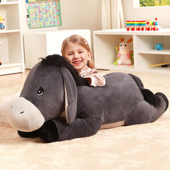 IKASA giant donkey plush placed in a bedroom setting for decor