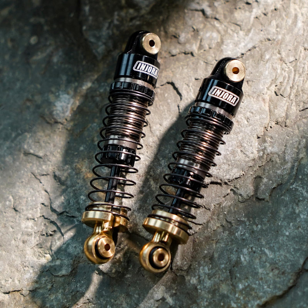 INJORA shocks with included alternative springs for tuning