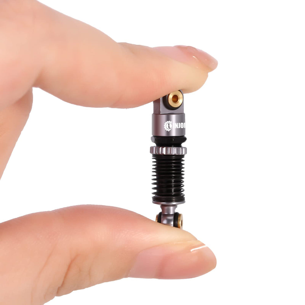 INJORA shocks compatible with Axial SCX24 Deadbolt micro crawler for enhanced action.
