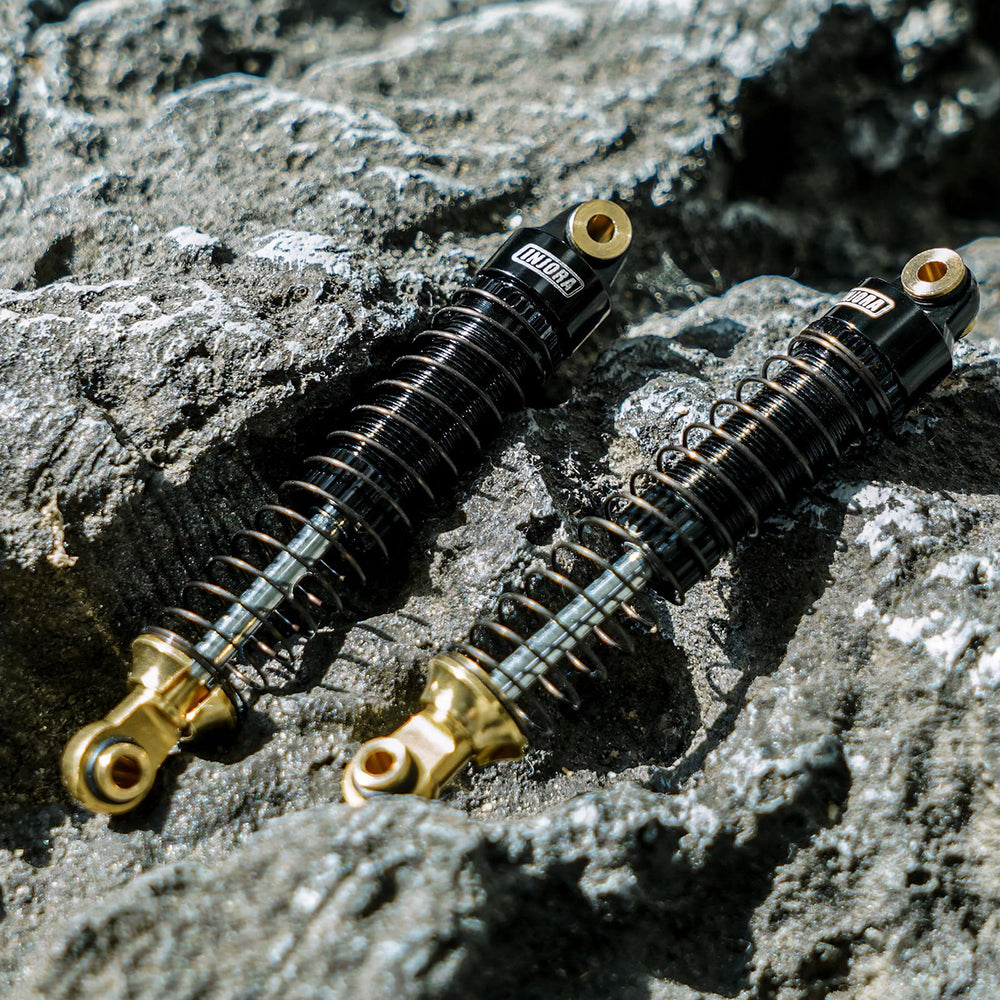 INJORA 59mm shocks installation image demonstrates easy upgrade for RC crawler builds.