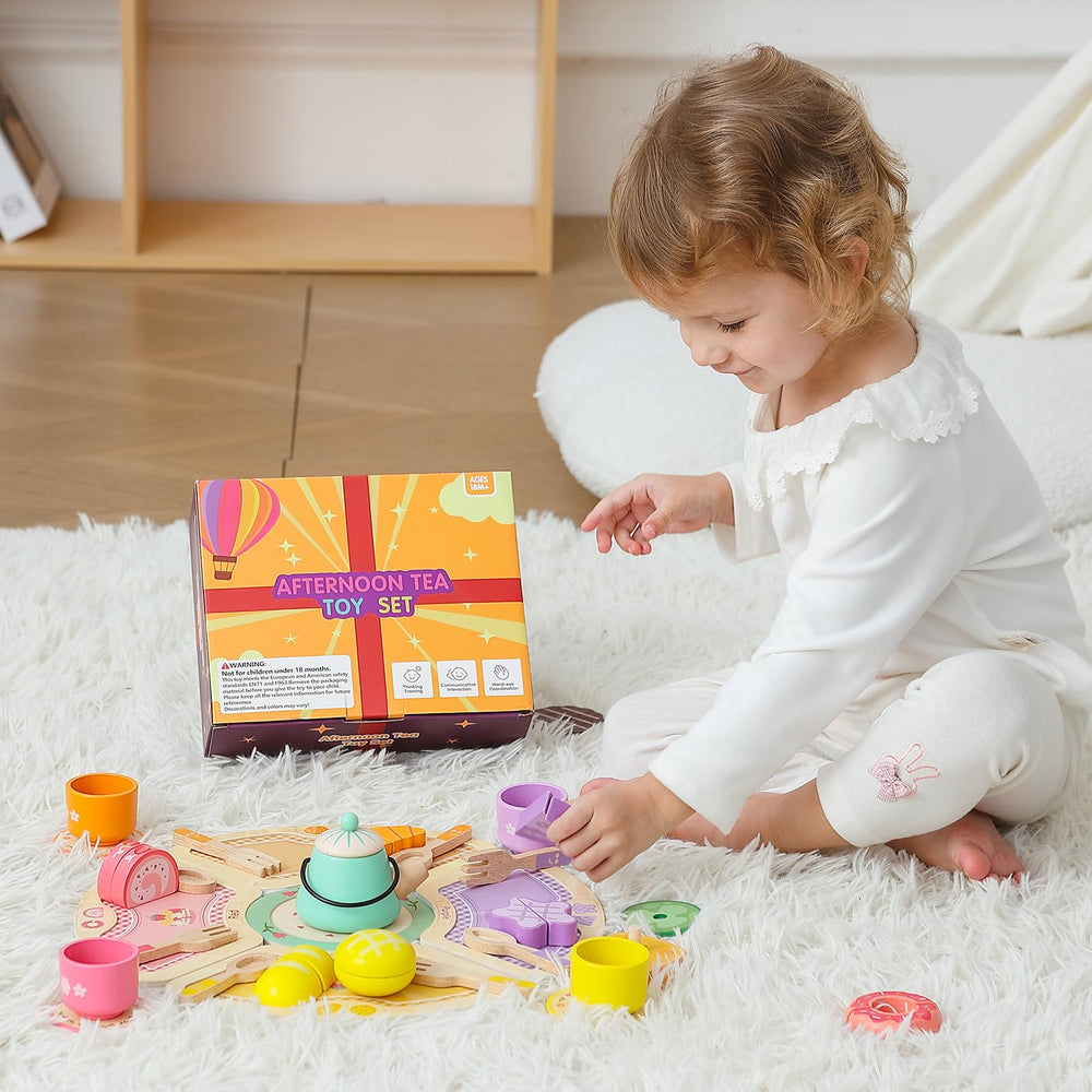 JAUNTY tea party set pieces arranged for playtime with stuffed animals.