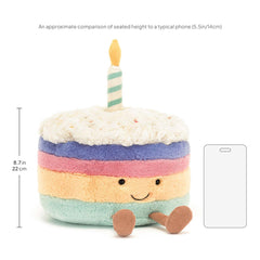 Jellycat Rainbow Birthday Cake plush held in arms, ideal for gifting and cuddles.