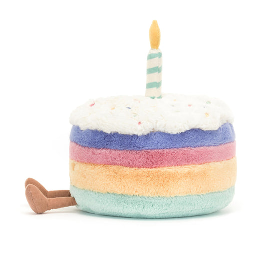 Jellycat Amuseables Rainbow Birthday Cake plush from the side, colorful layers brighten any shelf.