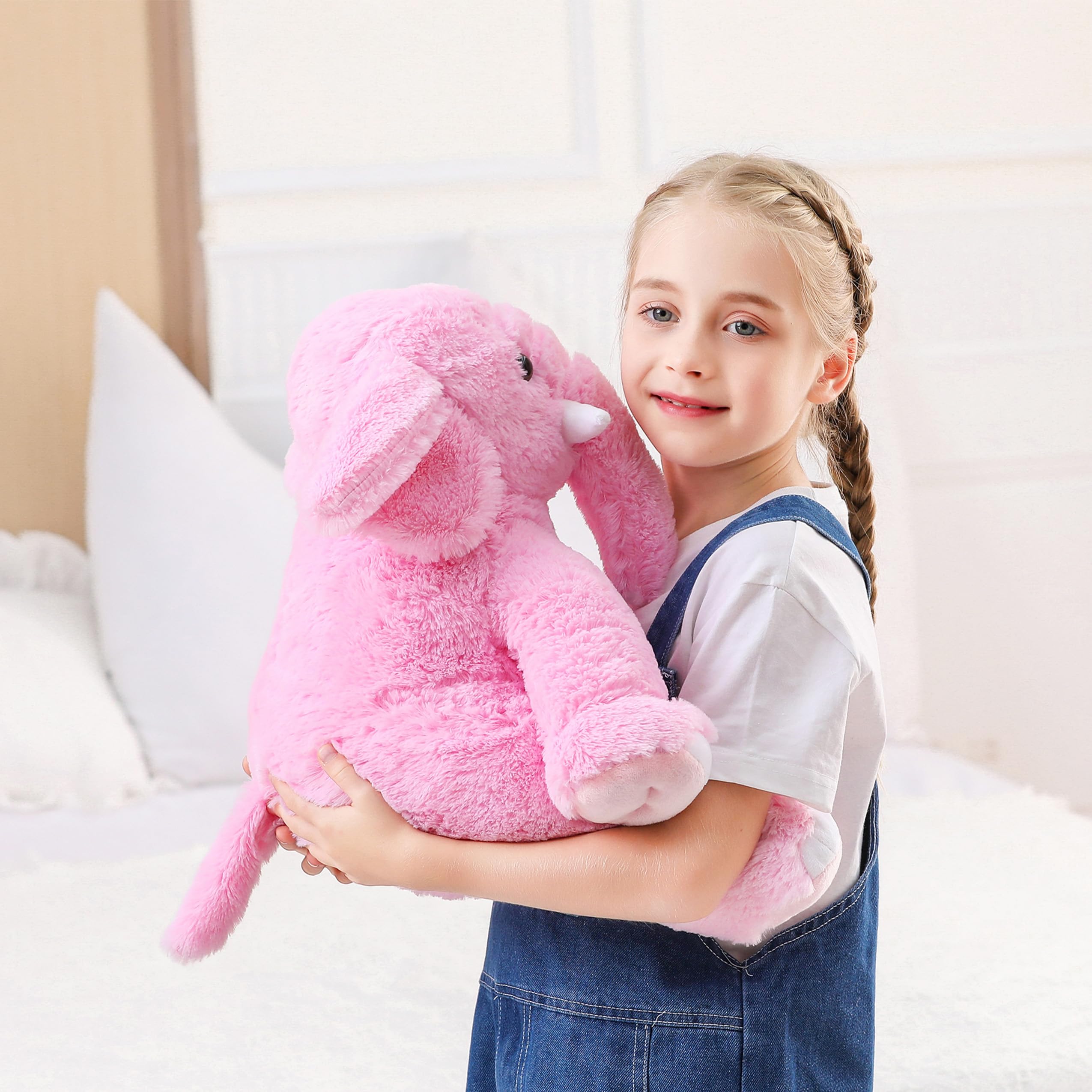 JellyMallow weighted elephant on bed, perfect cushion for sleepy evenings.