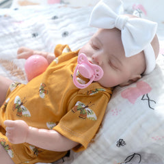 Jirachi reborn doll yellow-onesie closeup shows hand-rooted eyelashes