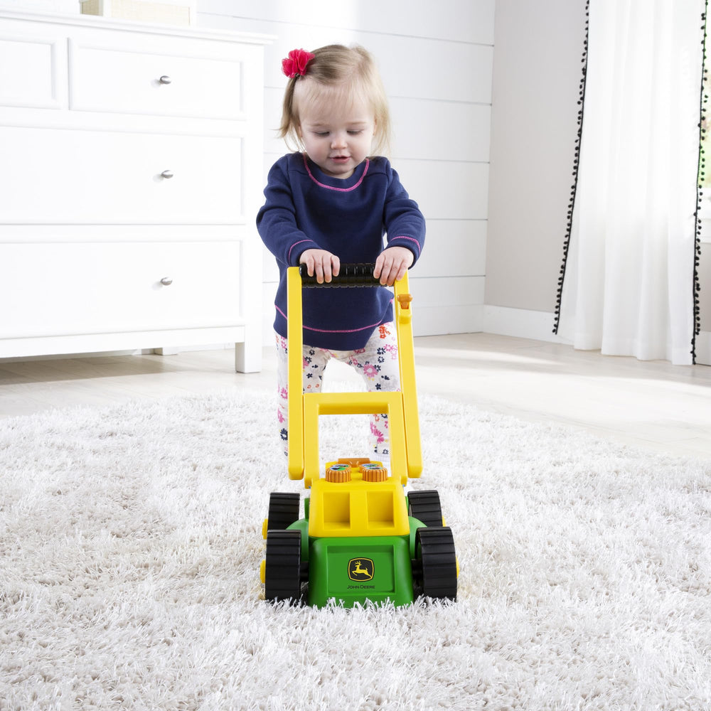 John Deere mower with extendable handle folds for easy storage after play.