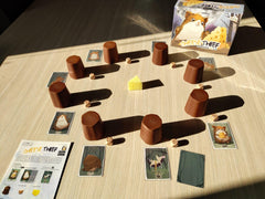 Tree-trunk cups enhance the whimsical mouse-themed table setup