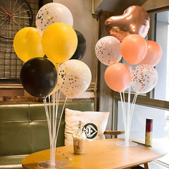 JOYPOP balloon stand centerpiece at a party enhances ambience.