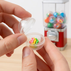 Holding Juvale gumball capsules demonstrates portable, kid-friendly prize packaging.