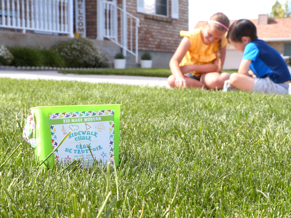 Kid Made Modern kids drawing on sidewalks shows safe outdoor creativity.
