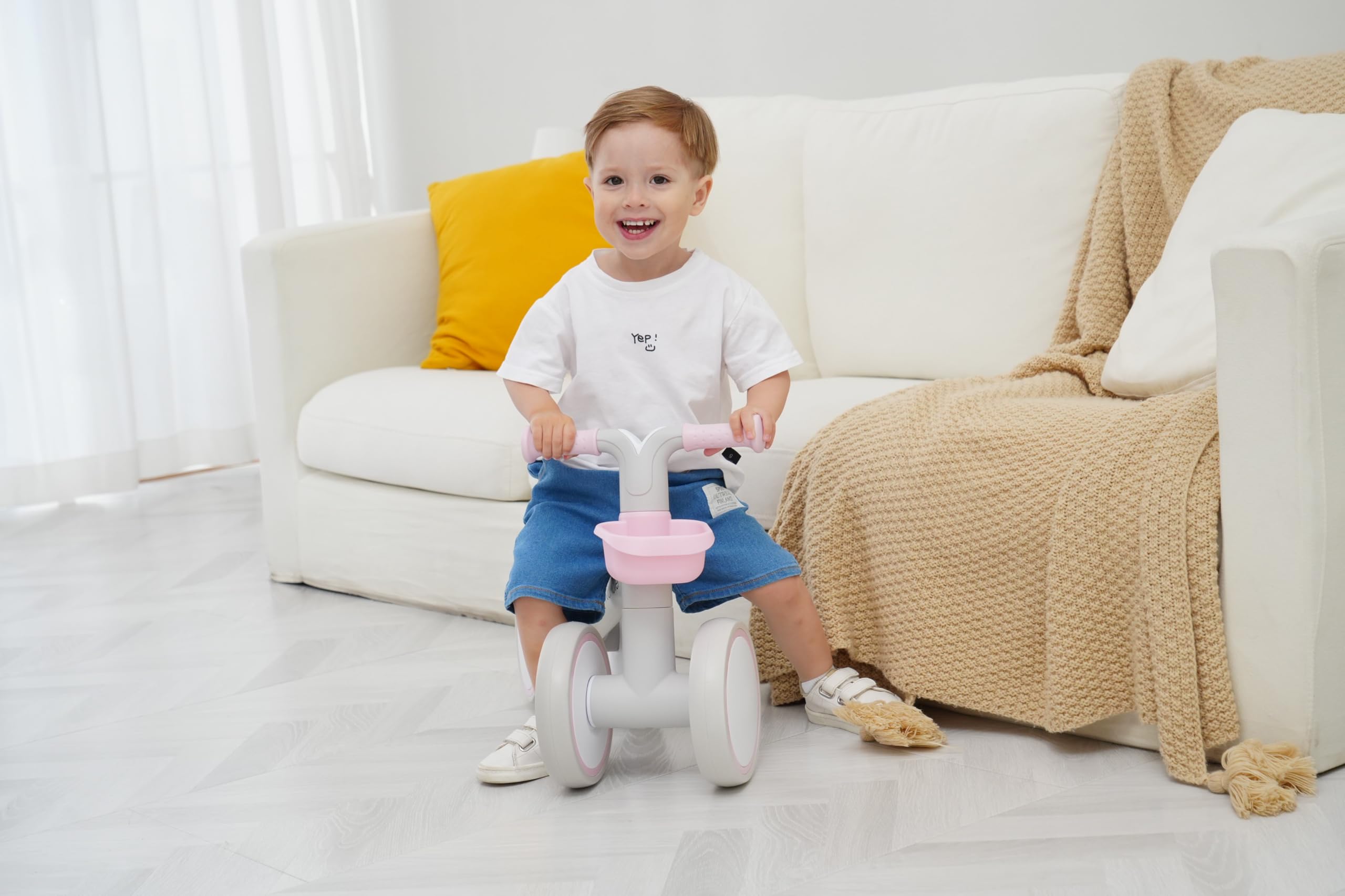 Child playing outdoors on pink KidRoller balance bike for early confidence