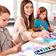 Kiggos kids painting session using colorful watercolors for imaginative landscapes.