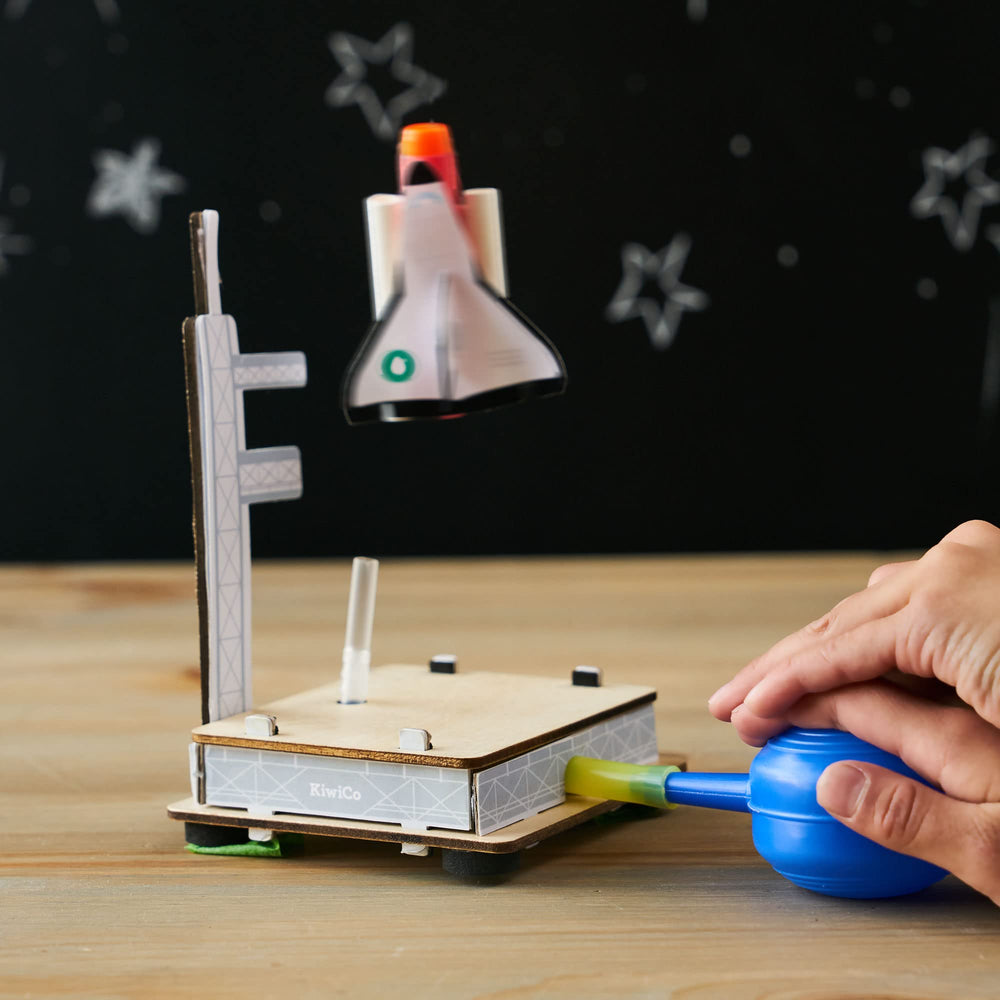 KiwiCo Astronaut Starter Kit pumps powered ships demonstrate propulsion in a playful setup.