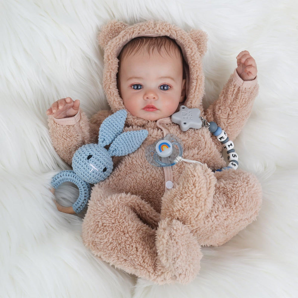 KSBD Reborn Baby Doll in grey onesie highlights authentic newborn charm.