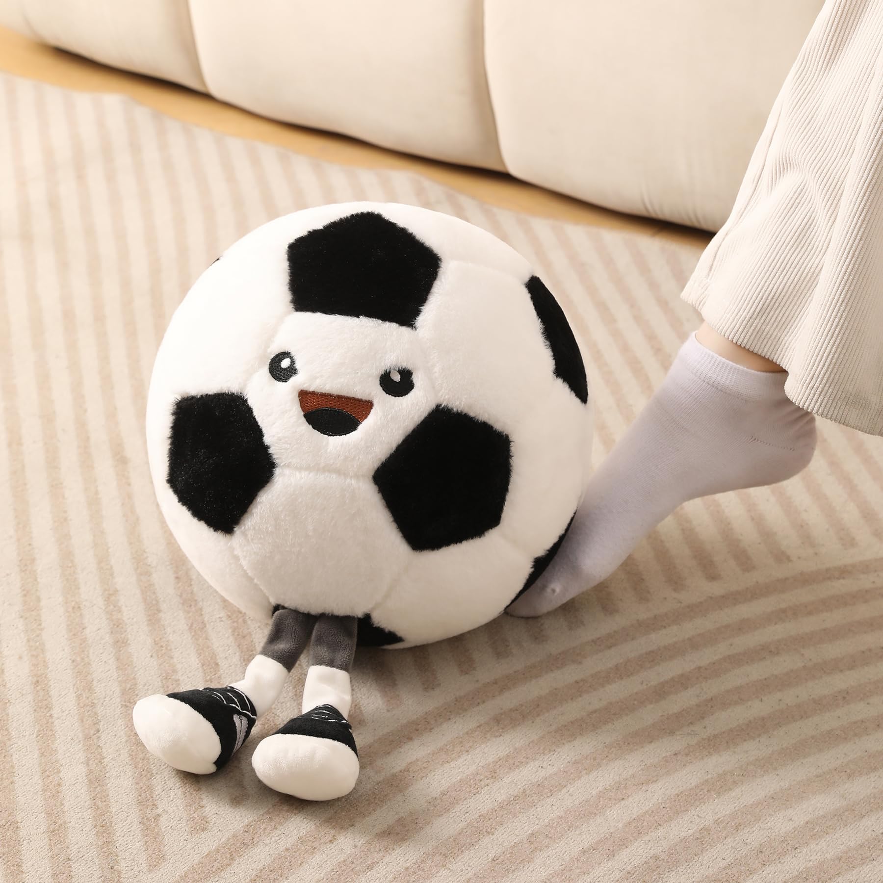 KUCCO-PILLOW soccer ball plush on a bed for decorative comfort.