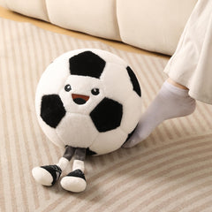 KUCCO-PILLOW soccer ball plush on a bed for decorative comfort.