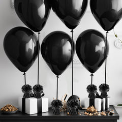 Close-up of KVCSYAW balloon weights used on a table decor setup