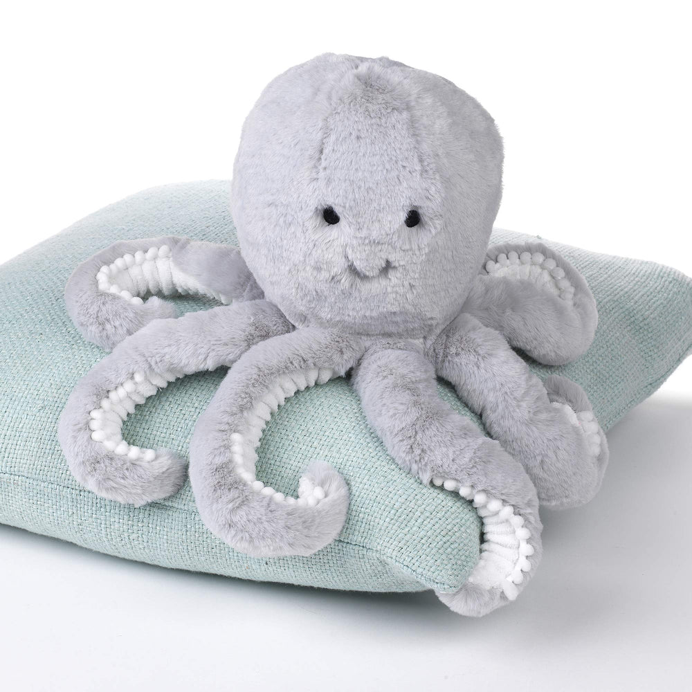 Inky features white pompoms along tentacles for playful nursery decor.