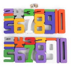 A toddler uses Lasoba blocks at a table to build numbers and patterns.