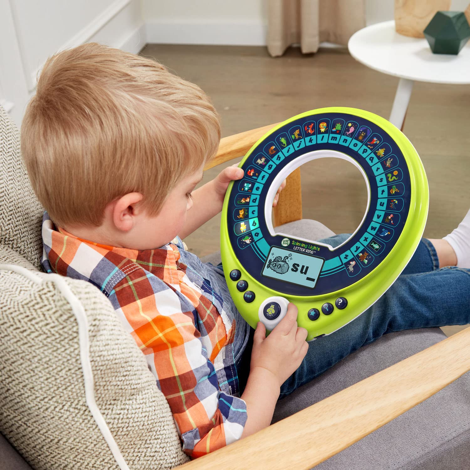 LeapFrog Spinning Lights Letter Ring with Sparky hiding behind letters for clues.