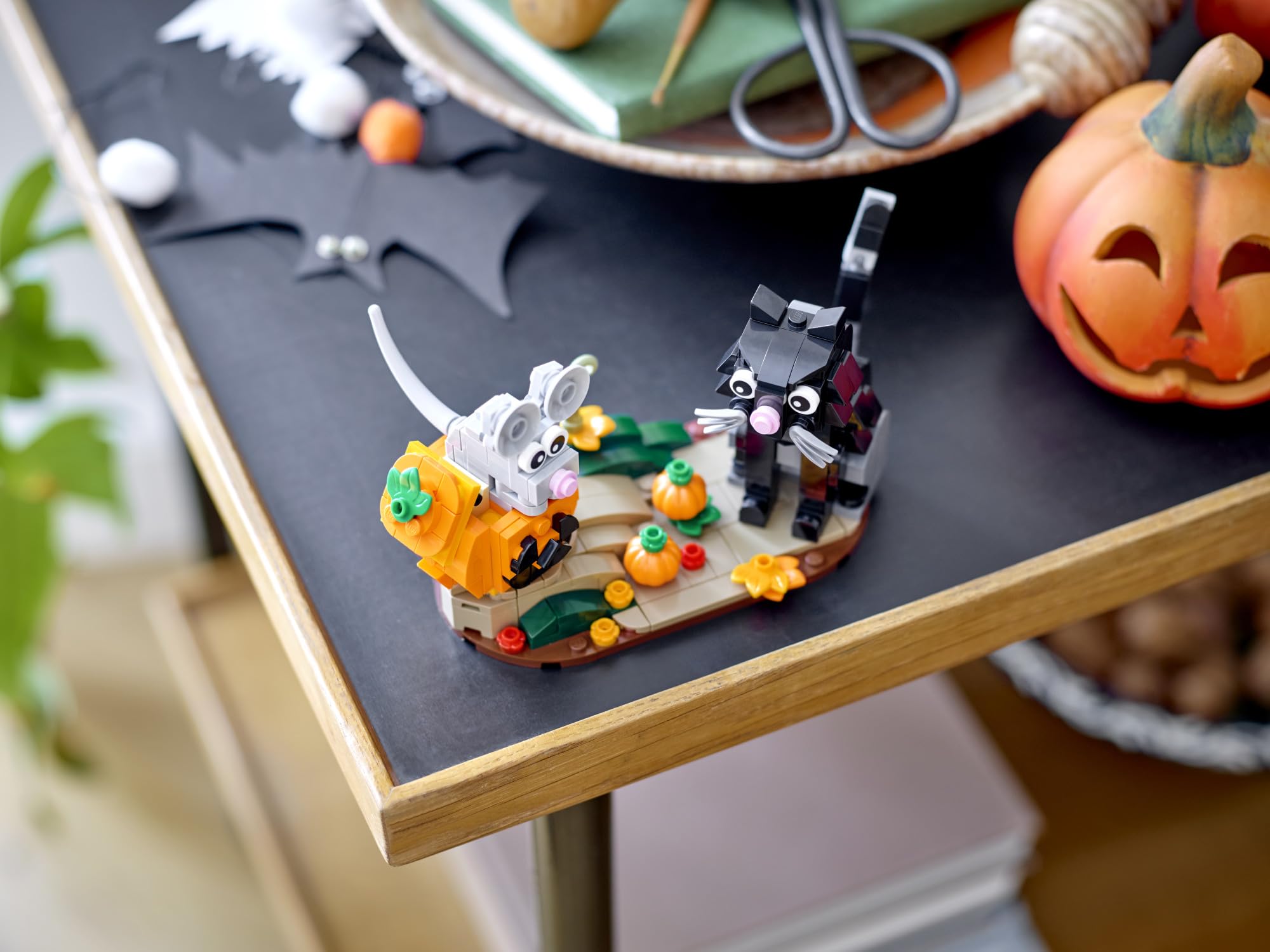LEGO Halloween Cat & Mouse 40570 pumpkin toy with mini pumpkins and autumn flowers for seasonal decor.