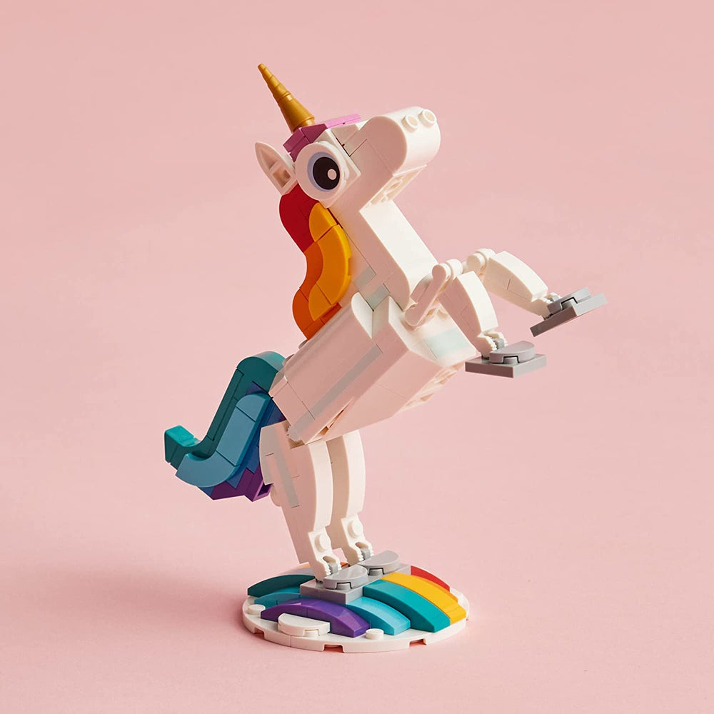 Hand holding LEGO unicorn model showing scale and portability for travel play