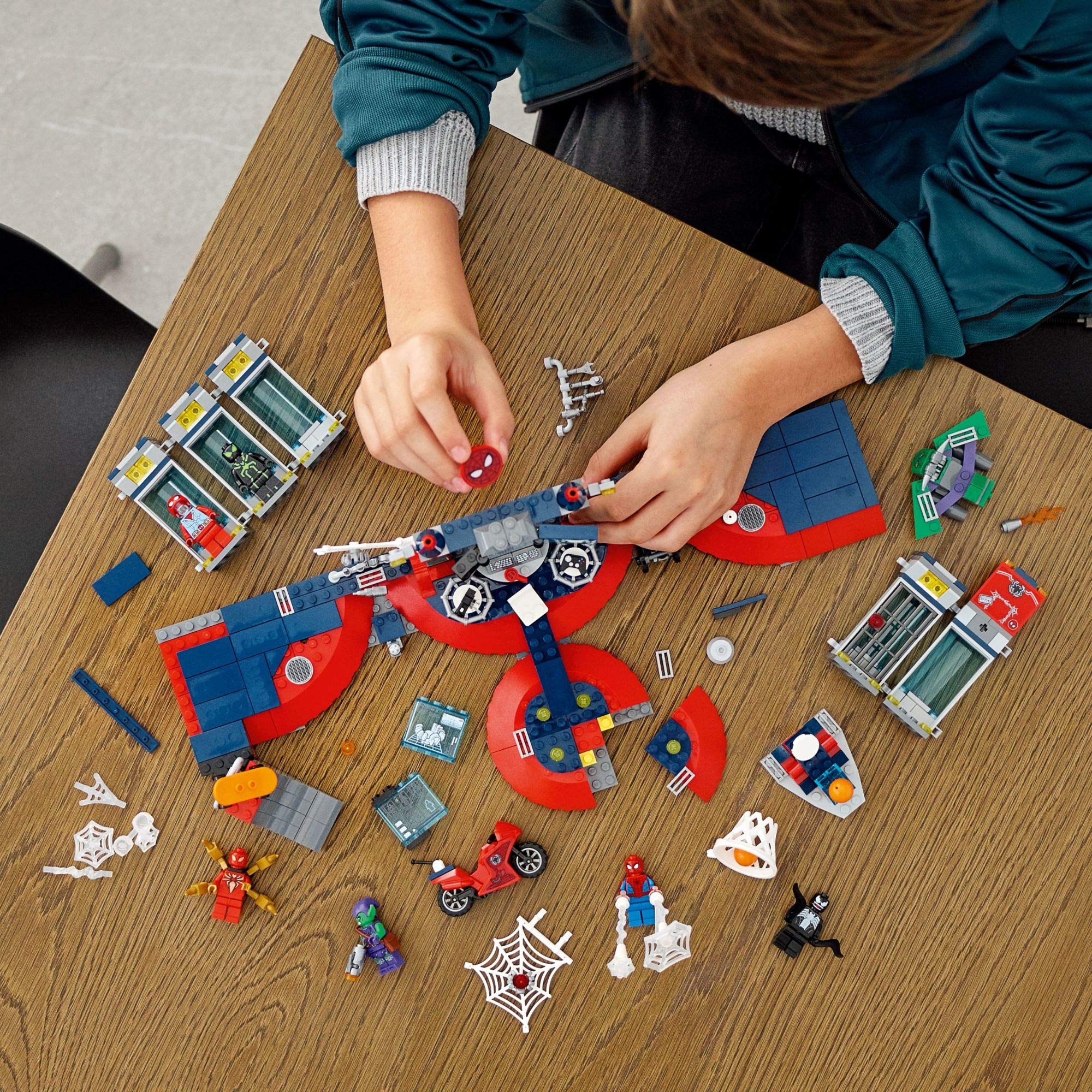 LEGO Spider-Man Attack on the Spider Lair—Iron Spider Suit and motorbike for gear-driven play.
