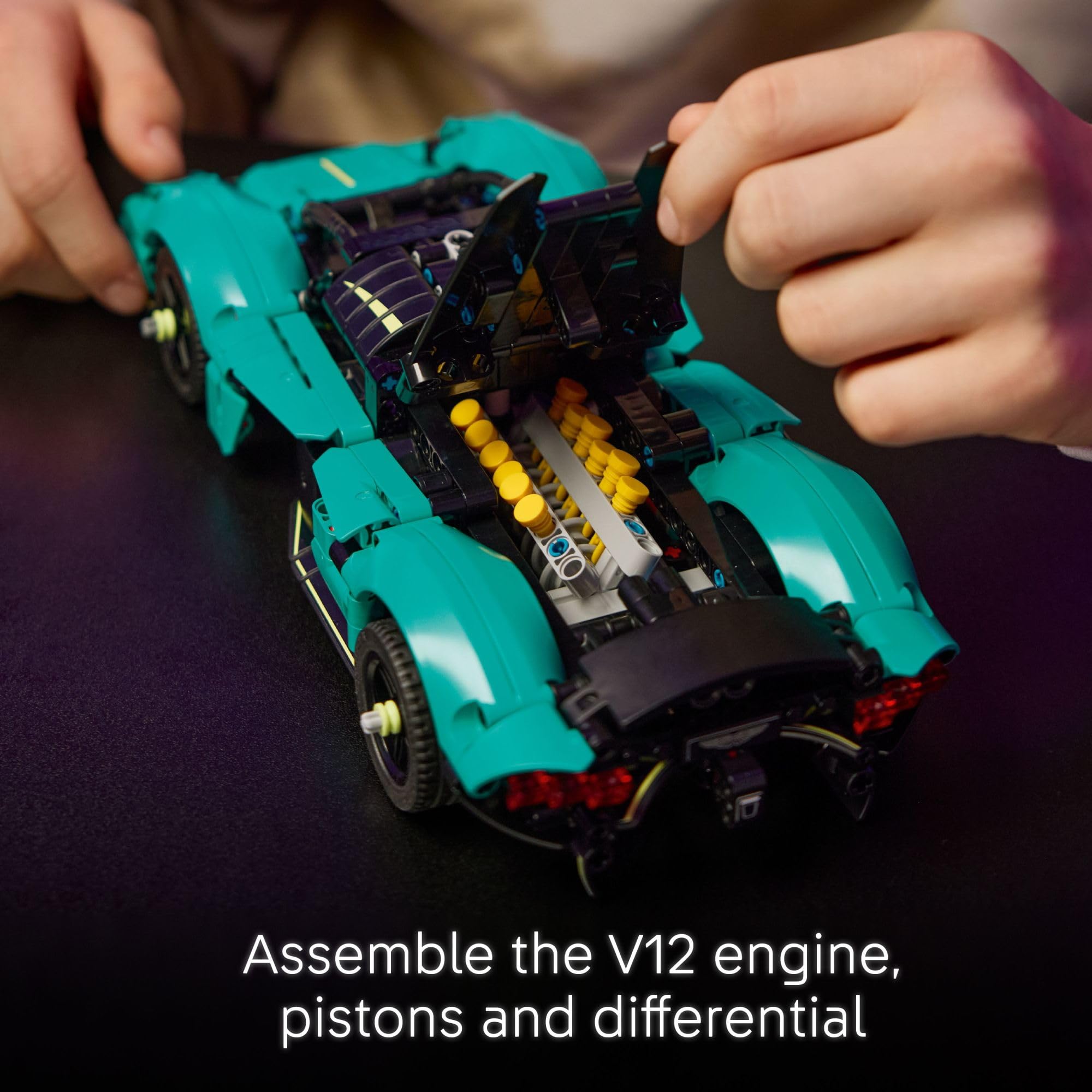 LEGO Technic Aston Martin Valkyrie teal engine pistons demonstrate moving parts for learning.