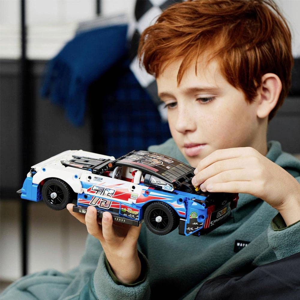 LEGO Technic NASCAR Camaro ZL1 model turned chassis shows internal mechanism in action.