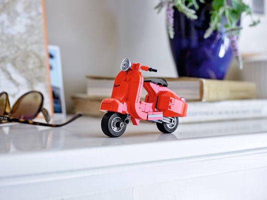 LEGO Vespa Mini Moped side view, vivid red color enhances shelf display.