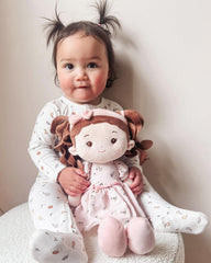 LeyaDoll doll held by a child to demonstrate cuddly hug