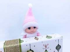 Close-up of LitoMagic baby elf's movable head and hands in soft pink fabric.