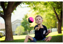 LMC Products three-pack mini footballs on display for party favors.